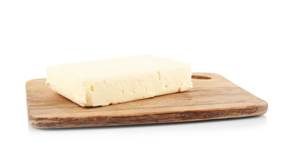 Wooden board with butter on white background