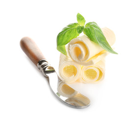 Delicious butter curls with basil leaves and shovel on white background, closeup