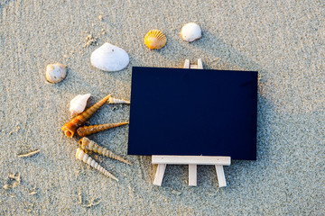 black board on sand beach .copy space area for concept