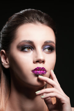 Beautiful young woman with creative makeup on dark background, closeup