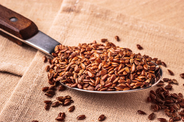 Flax seeds linseed on kitchen spoon