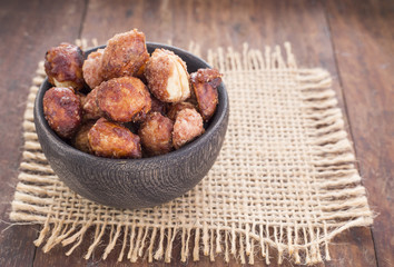 Sugared peanuts on the wooden background