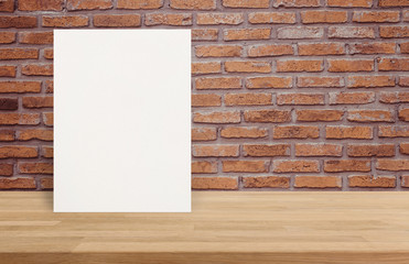 Blank White paper poster on wood table top at old brick wall,Template mock up for adding your design.