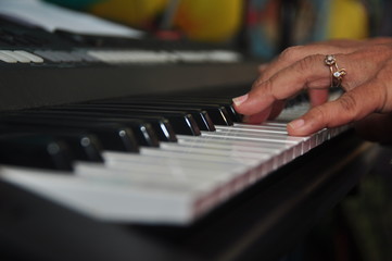 Fototapeta na wymiar Close Up Of Hands Playing Electric Piano Keyboard