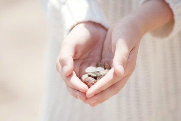 hands holding pebbles