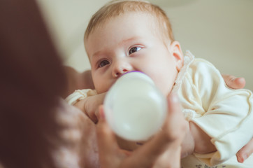 A young mother, feeding the child