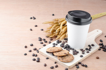 Coffee cup and coffee beans on wooden background