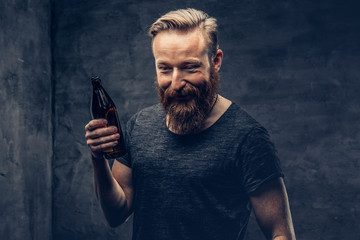 A man holds beer bottle.