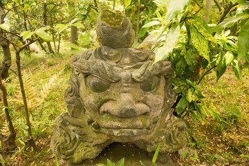 A stone statue in a garden
