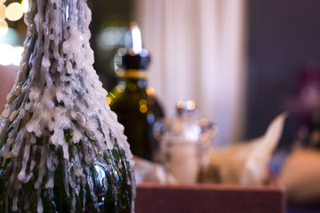 Wine bottle candlestick with melted wax