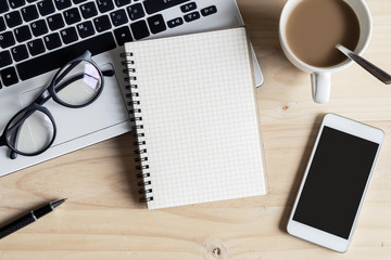 notebook with smart phone and cup of coffee