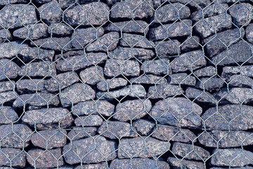 a stone wall with a metal grate