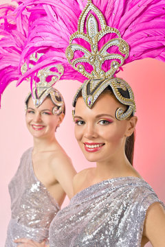 Beautiful Girls in carnival costume with pink feathers.