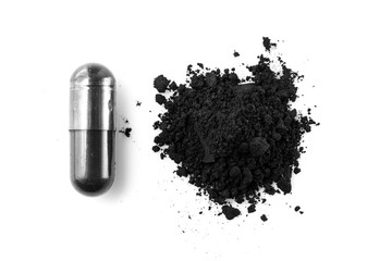 Activated charcoal capsule and power isolated on white