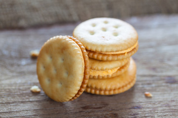 Crackers with cream on wooden background