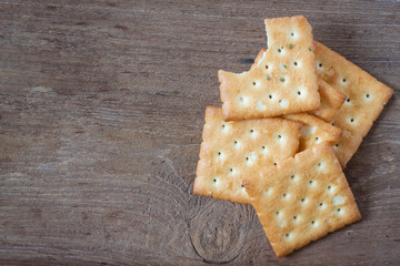 Crackers or biscuit on wooden background, top view