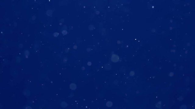 Moving particles blur on blue background