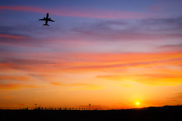 Fototapeta na wymiar airplain flight during sunset 
