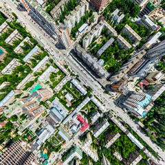 Naklejka premium Aerial city view with crossroads and roads, houses, buildings, parks and parking lots, bridges. Helicopter drone shot. Wide Panoramic image.