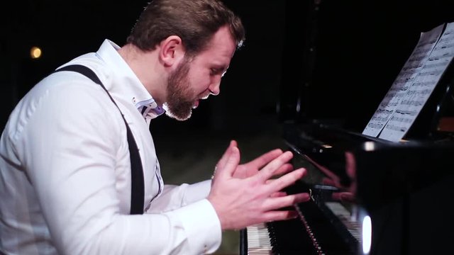 man nervously playing the piano
