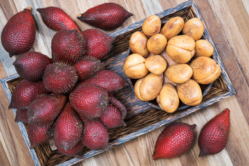 Salak or Salacca zalacca tropical fruit in wooden plate