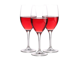 Three wineglasses with some wine isolated on white