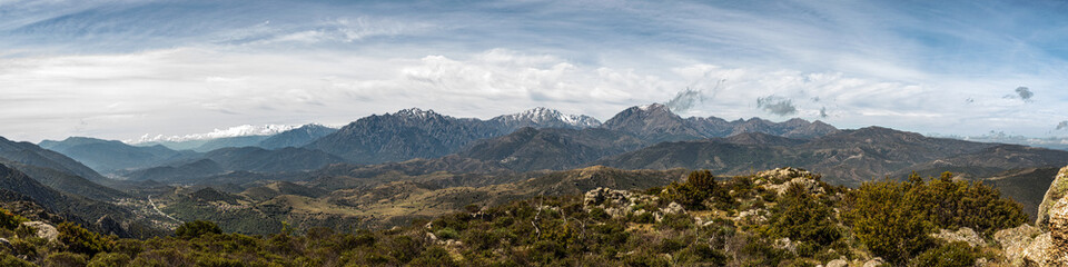 Fototapeta na wymiar Panoramic view of snow capped mountains of northern Corsica