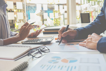 Business concept. Business people discussing the charts and graphs showing the results of their successful teamwork.