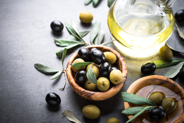 Black and green olives and olive oil.