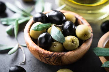 Foto op Plexiglas Black and green olives in wooden bowl © nadianb