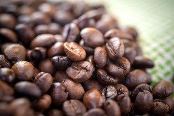 Roasted coffee beans on a wooden background