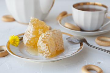 Tea with honey on white background