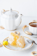 Tea with honey on white background