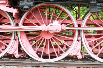 Red wheels and pistons on an old locomotive