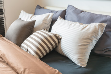 Fototapeta na wymiar set of pillows on modern bed in modern bedroom