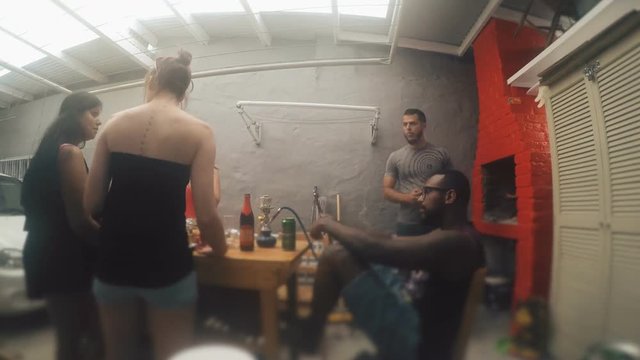 People eating together sitting at the table in garage, Barcelona Time lapse