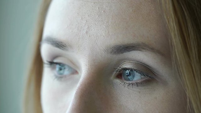 Girl with beautiful blue eyes and pale complexion looking to the camera, steadycam shot
