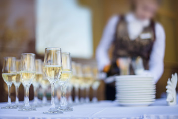 waiter is pouring alcohol and served table