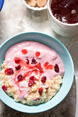 Breakfast porridge with mashed banana, cherry yoghurt, dried cranberries and earl grey tea 