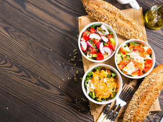 Colorful vegetable salad bowl for lunch on wooden rustic background
