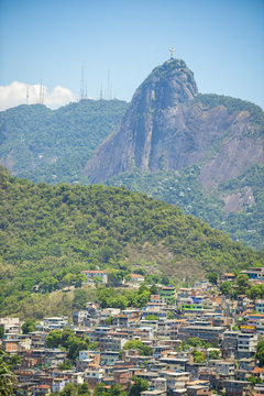 Scenic view of the dramatic mountain skyline of Rio de Janeiro, Brazil with a crowded Brazilian community favela shanty town in the foreground