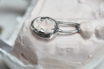 Gray dental prosthesis teeth mold, clay human gums model