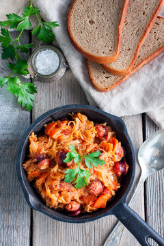 Cabbage stew with grilled sausage - traditional dish of german cuisine, Selective focus