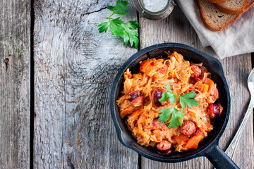 Stewed cabbage with sausages, German cuisine, horizontal, copy space, top view