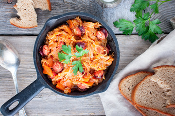 Stewed cabbage with sausages, German cuisine, horizontal, top view