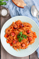 Cabbage stew with grilled sausage - traditional dish of german cuisine, Selective focus