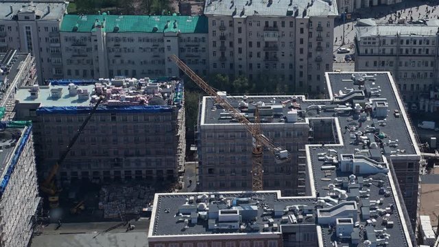 Aerial cityscape view with crane working at building construction. Moscow. Time lapse form view point
