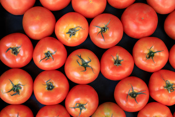 Group of ripe fresh red tomatoes on a market