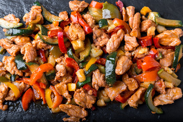 Beef Fajitas with colorful bell peppers in slate plate.  Top view.