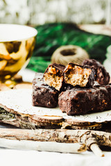 Homemade raw chocolate candy snickers bars. Selective focus. © harmoony